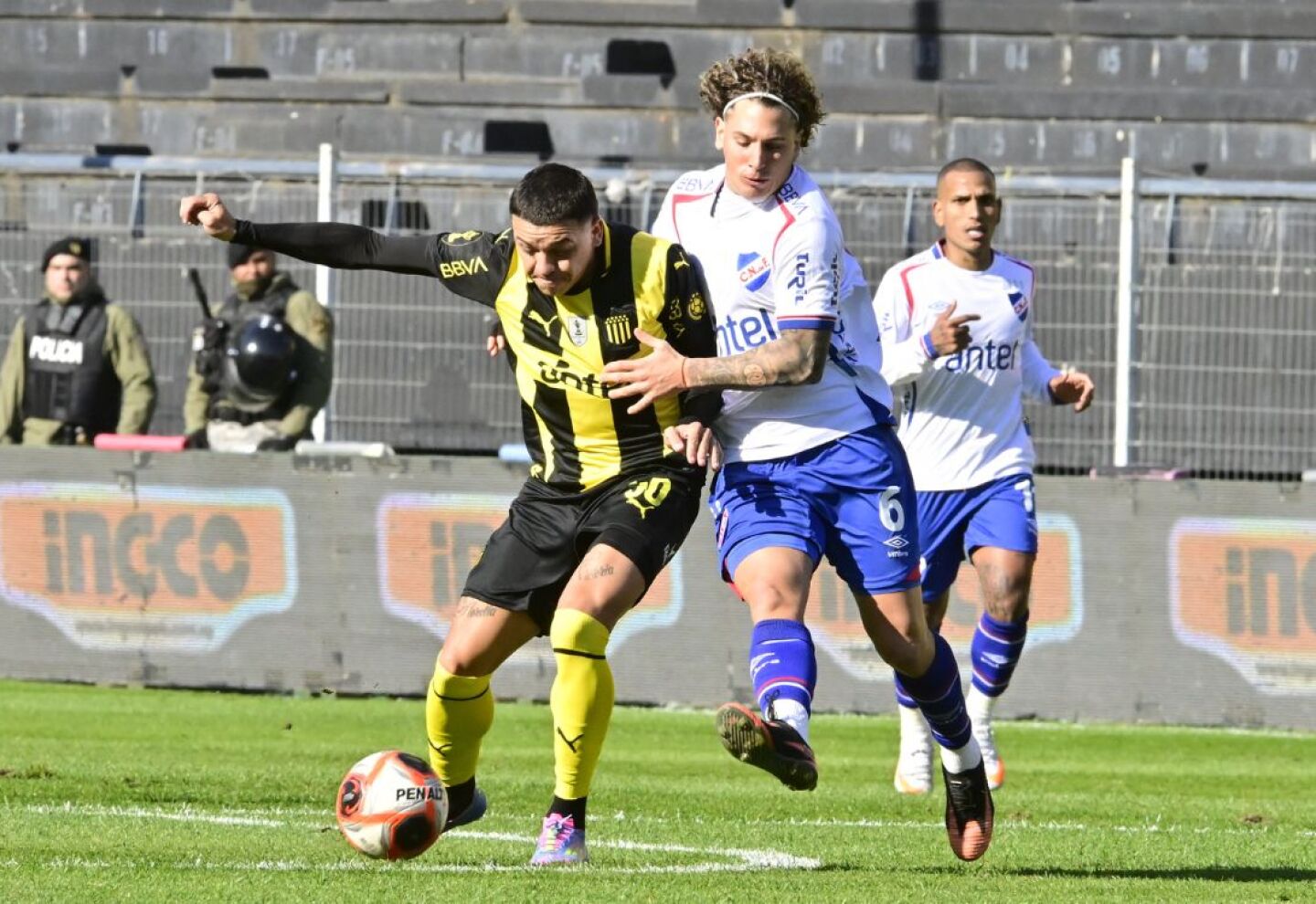Diego García y Luciano Boggio disputan la pelota en el clásico entre Peñarol y Nacional en el estadio Campeón del Siglo.