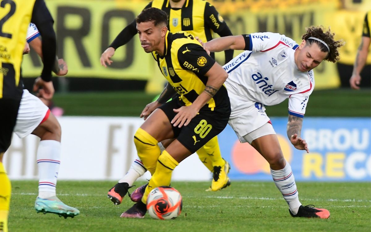 David Terans, con pelota, ante la marca de Luciano Boggio en el clásico entre Peñarol y Nacional.