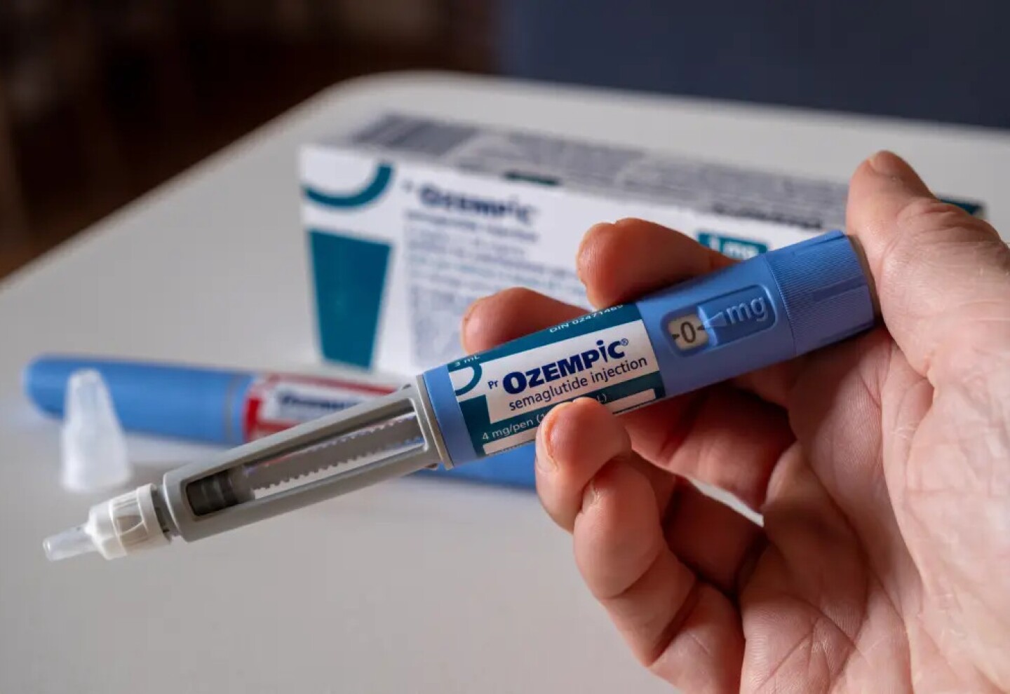 hand-holding-ozempic-semaglutide-injection-101613639_ade780.jpg