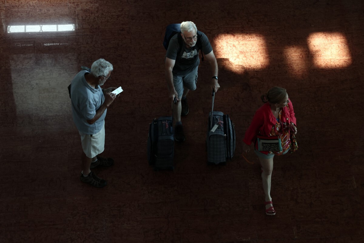 Pasajeros transportan su equipaje en el aeropuerto Roissy Charles-de-Gaulle, a las afueras de París, el 3 de julio de 2025.
