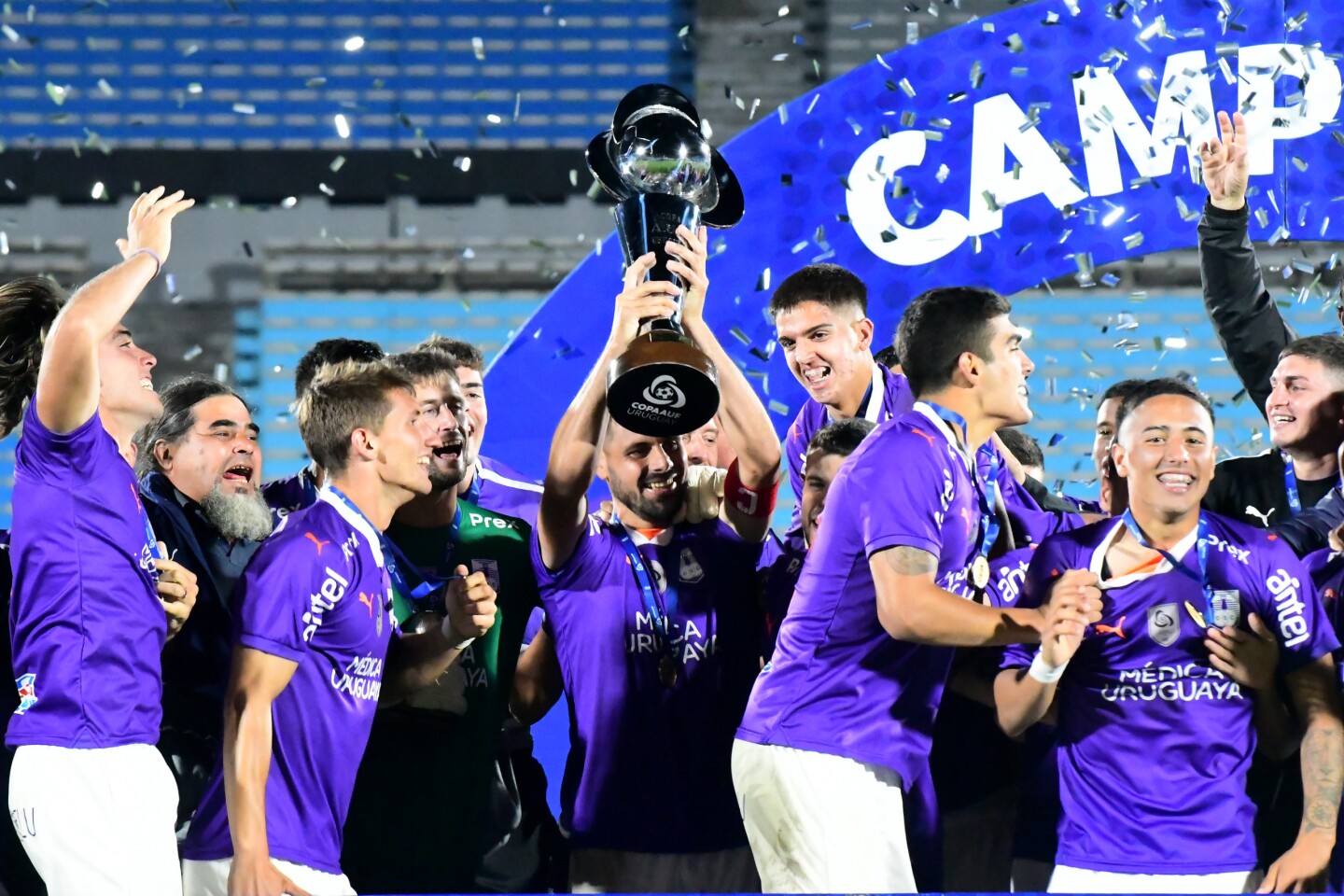 Guillermo De los Santos con el trofeo de la Copa AUF Uruguay junto a sus compañeros.
